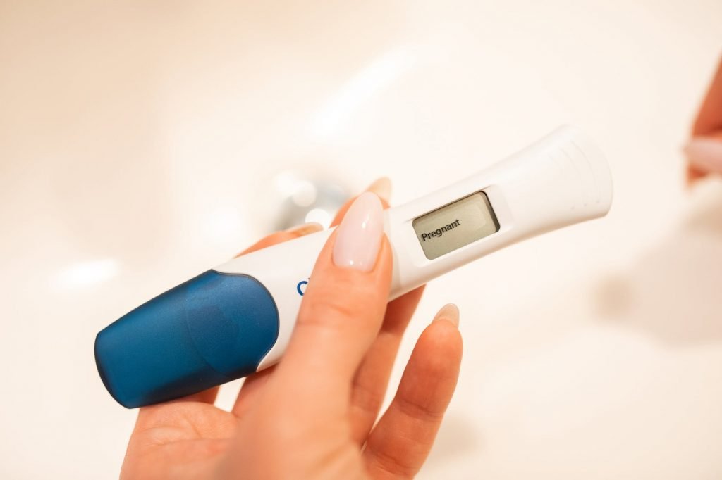 a woman hand holding a digital pregnancy test kit
